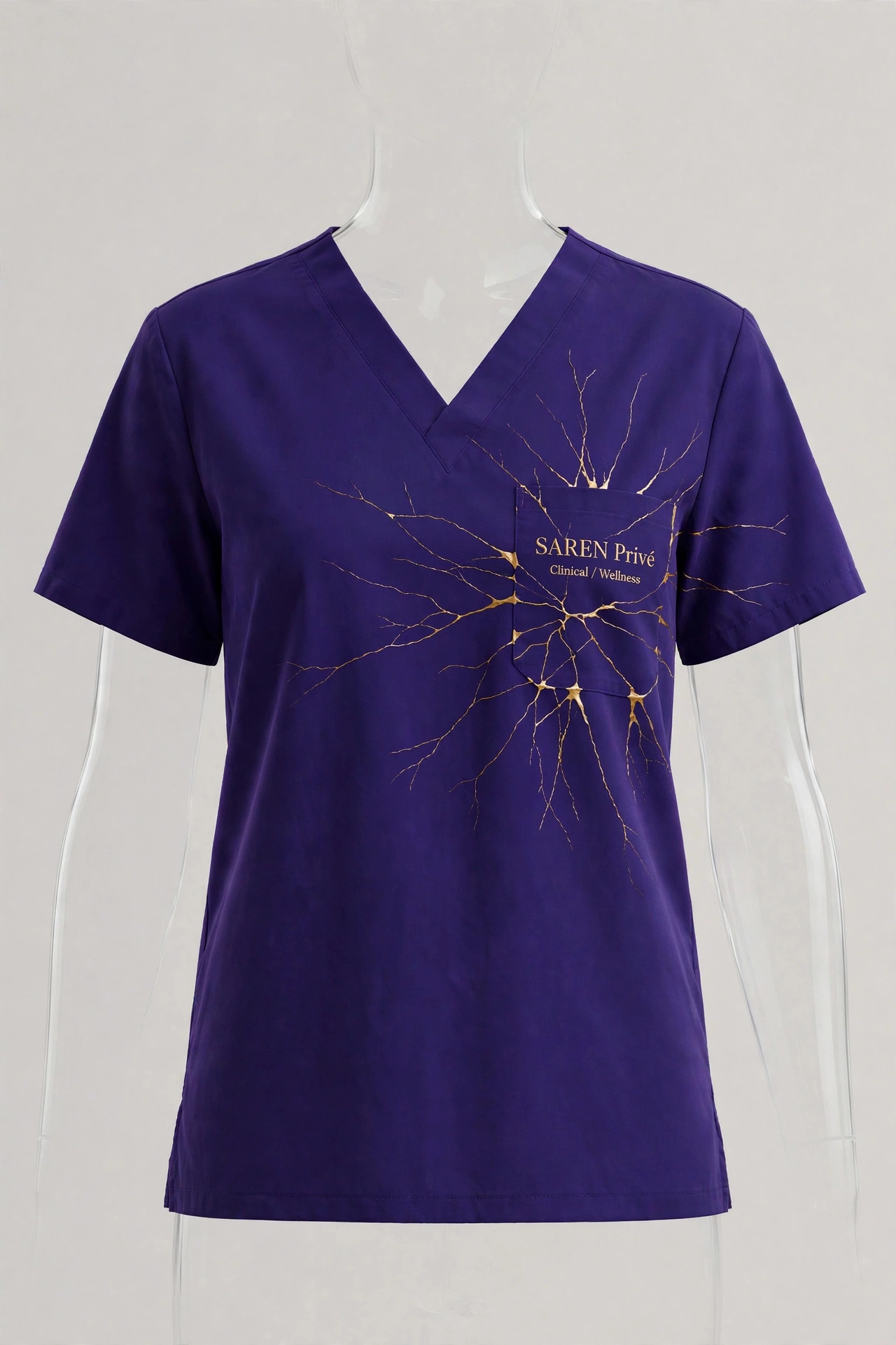Final deep-purple SAREN Privé v-neck scrub top with gold Clinical and Wellness embroidery at the left chest pocket and prominent gold-repair crack detail